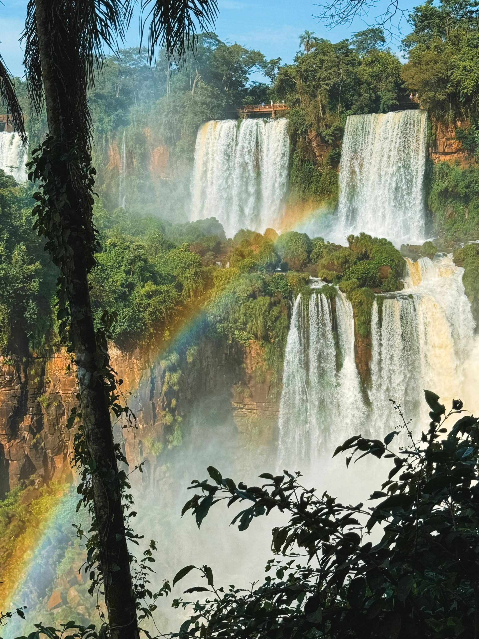 Stunning view of Iguazu Falls in Argentina with a vibrant rainbow.